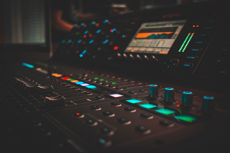 Title illustration: atmospheric image of a control desk in a sound studio with lights glowing in the dark